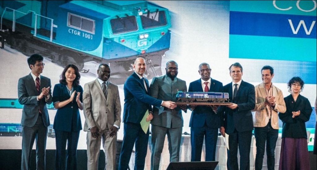 Executives from Wabtec, SimFer and Guinean government officials celebrate the locomotive order for the Simandou mining project.